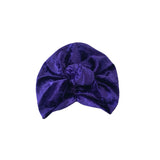 Purple velvet turban on a white background