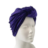 Purple headscarf on a mannequin head against a white background