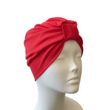 Red headscarf on a mannequin head against a white background