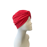 Red headscarf on a mannequin head against a white background