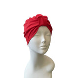 Red headscarf on a mannequin head against a white background