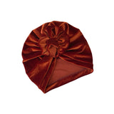Brown velvet turban with a large bow on a white background