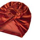 Brown velvet turban with a large bow on a white background