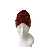 Brown headband on a mannequin head against a white background
