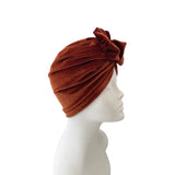 orange turban on a mannequin head against a white background