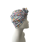 Floral patterned headscarf on a mannequin head against a white background
