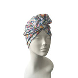 Floral patterned headscarf on a mannequin head against a white background