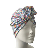 Floral patterned headscarf on a mannequin head against a white background