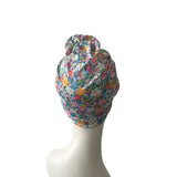Floral-patterned headscarf on a mannequin head against a white background