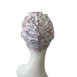 Floral patterned headscarf on a mannequin head against a white background