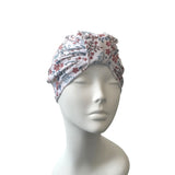 Floral patterned headscarf on a mannequin head against a white background