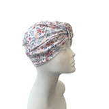 Floral patterned headscarf on a mannequin head against a white background