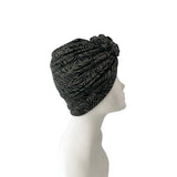 Black patterned headscarf on a mannequin head against a white background