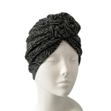 Black patterned headscarf on a mannequin head against a white background