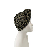 Leopard print headscarf on a mannequin head against a white background