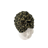 Leopard print headscarf on a mannequin head against a white background