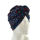 Navy blue headscarf with colorful patterns on a mannequin head against a white background ireland