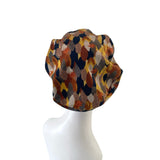 Patterned headscarf on a mannequin head against a white background