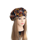 Mannequin head wearing a patterned headscarf on a white background