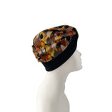 Colorful patterned headscarf on a mannequin head against a white background