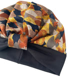 Turban with autumn leaf pattern on a white background