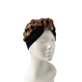 Turban with a checkered pattern on a mannequin head against a white background