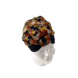 Patterned headscarf on a mannequin head against a white background
