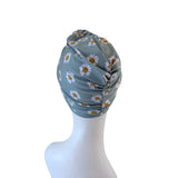 Floral patterned headscarf on a mannequin head against a white background