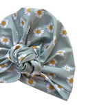 Turban with daisy pattern on a light green background