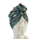 Floral patterned headscarf on a mannequin head against a white background