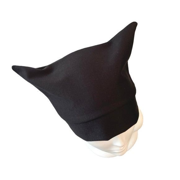 Black pointed hat on a mannequin head against a white background