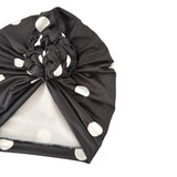 Black headscarf with white polka dots on a white background