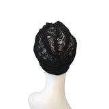 Black lace headscarf on a mannequin head against a white background
