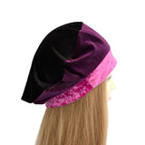 Mannequin head with a black and purple velvet hat on a white background