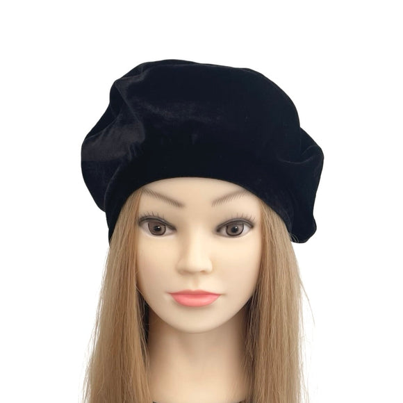 Black beret on a mannequin head with long blonde hair against a white background