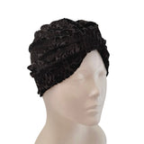Black textured head wrap on a mannequin head against a white background