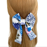 Hair bow with blue and white pattern on a mannequin head