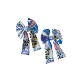 Two patterned hair bows on a white background