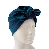 Blue headscarf with a bow on a mannequin head against a white background
