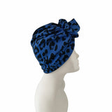 Blue leopard print headscarf on a mannequin head against a white background