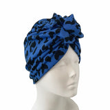 Blue patterned headscarf on a mannequin head against a white background