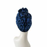 Blue leopard print headscarf on a mannequin head against a white background