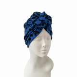 Blue patterned headscarf on a mannequin head against a white background