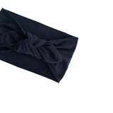 A dark navy blue fabric headband with a knotted twist detail, shown on a plain white background.