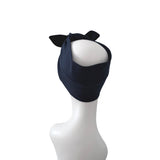 A dark navy blue fabric headband with two small pointed ear-like tabs on top, displayed on a white mannequin head against a plain white background.