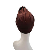 Brown headscarf on a mannequin head against a white background