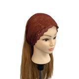 Brown lace headscarf on a mannequin head with long brown hair against a white background