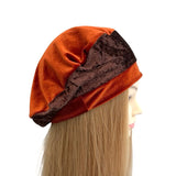 Mannequin head wearing a rust-colored velvet turban with brown trim on a white background ireland