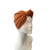 Brown headscarf on a mannequin head against a white background