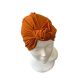 Brown headscarf on a mannequin head against a white background